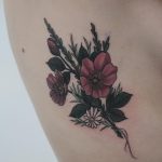 Wild roses tattoo on the rib cage
