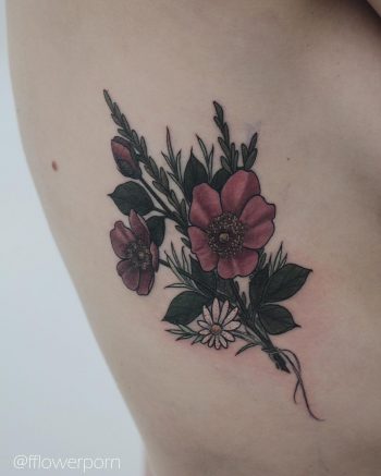 Wild roses tattoo on the rib cage