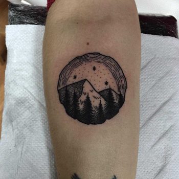 Wood slice-shaped landscape tattoo
