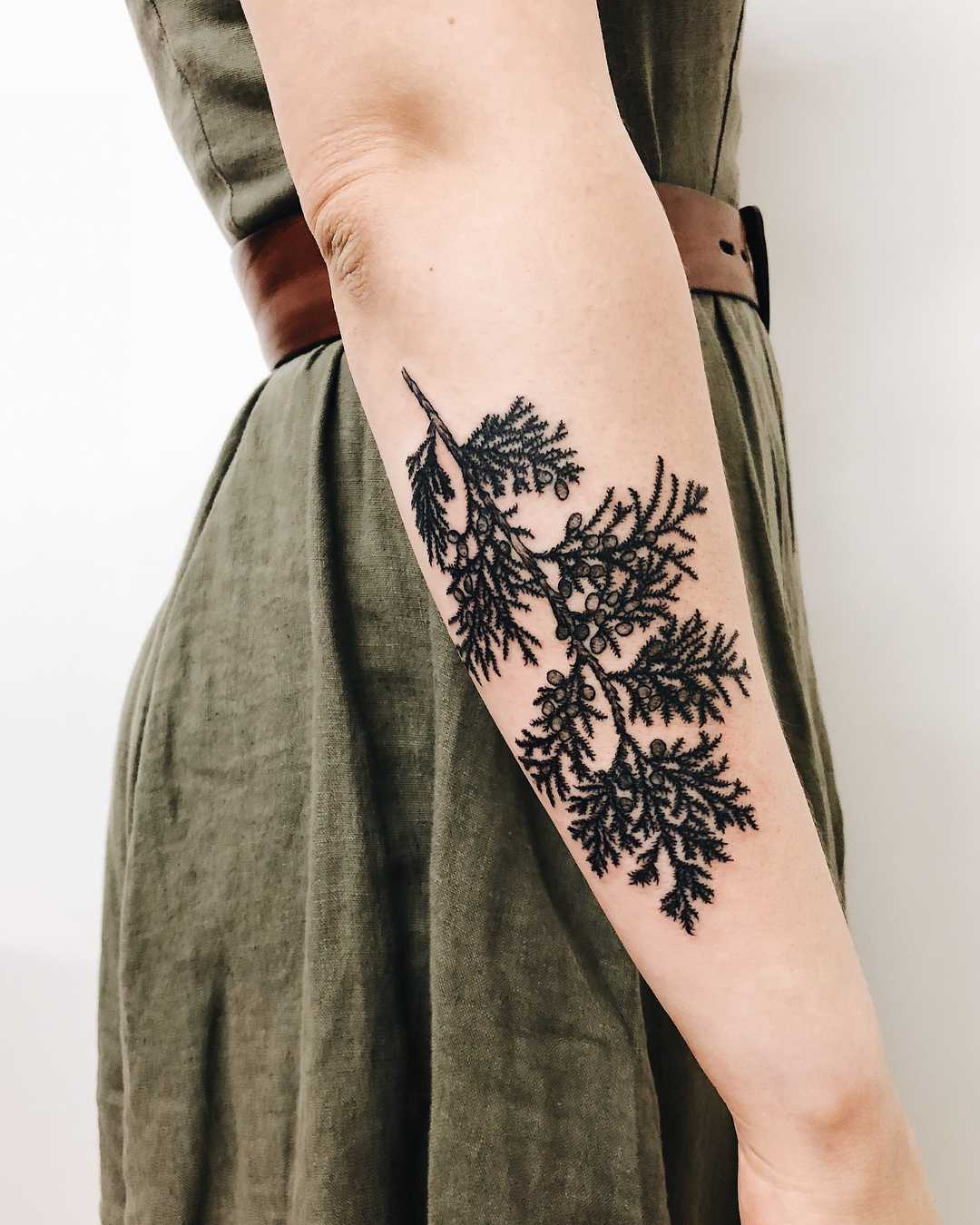 A black branch tattoo by Finley Jordan