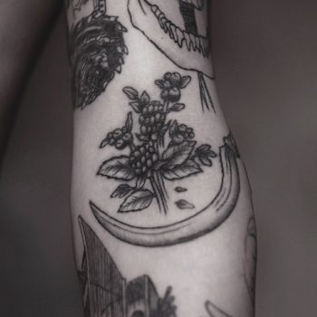 Berries and sickle tattoo