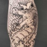 Blackwork dragon tattoo on the calf