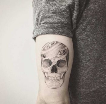 Galactic skull tattoo on the triceps