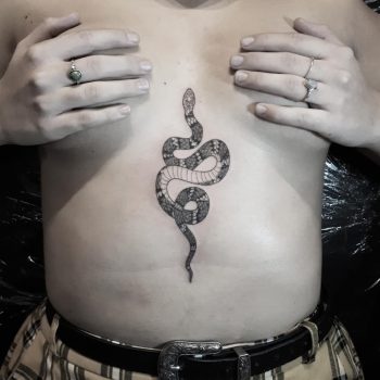 Grey snake tattoo on the belly