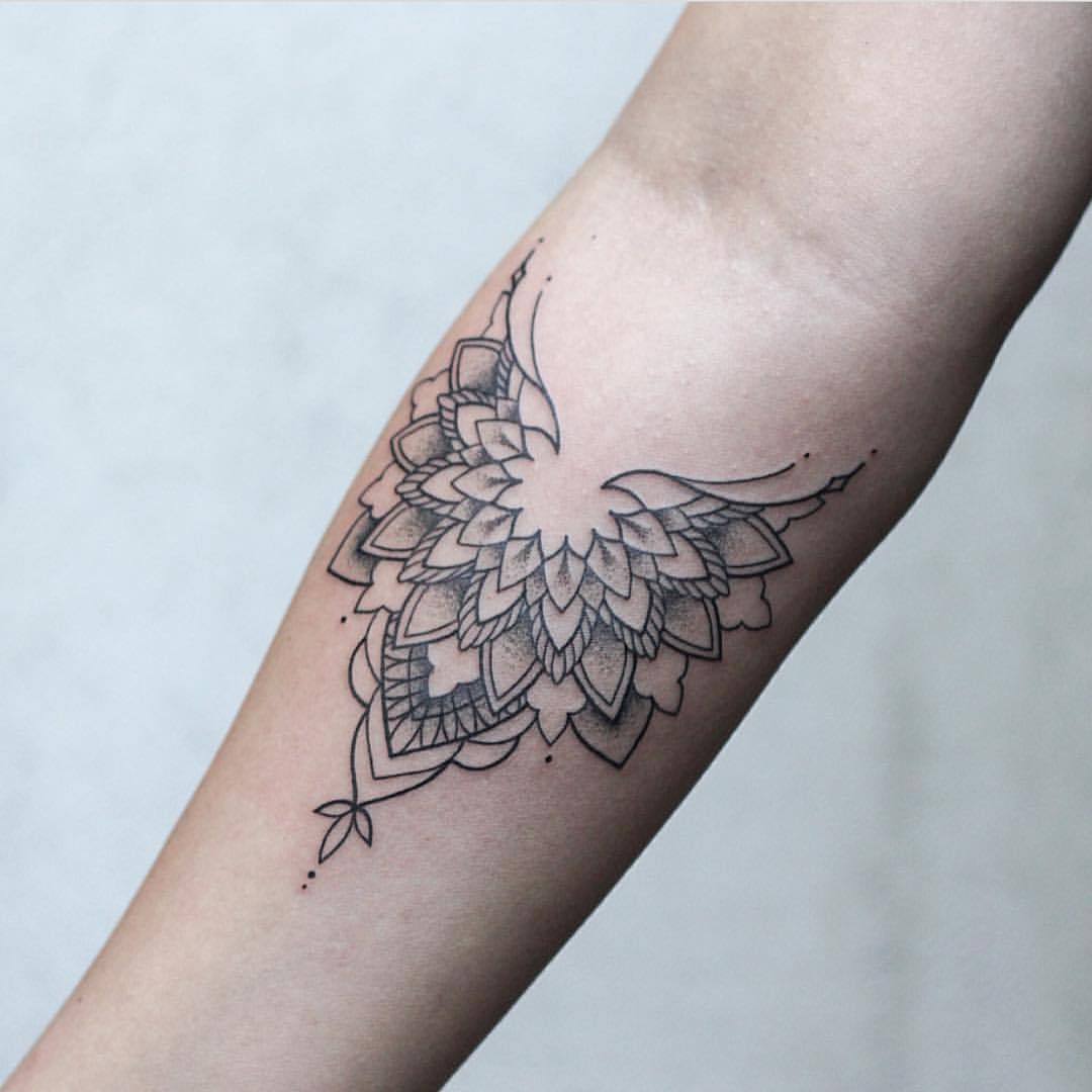 Mandala tattoo on the upper arm.