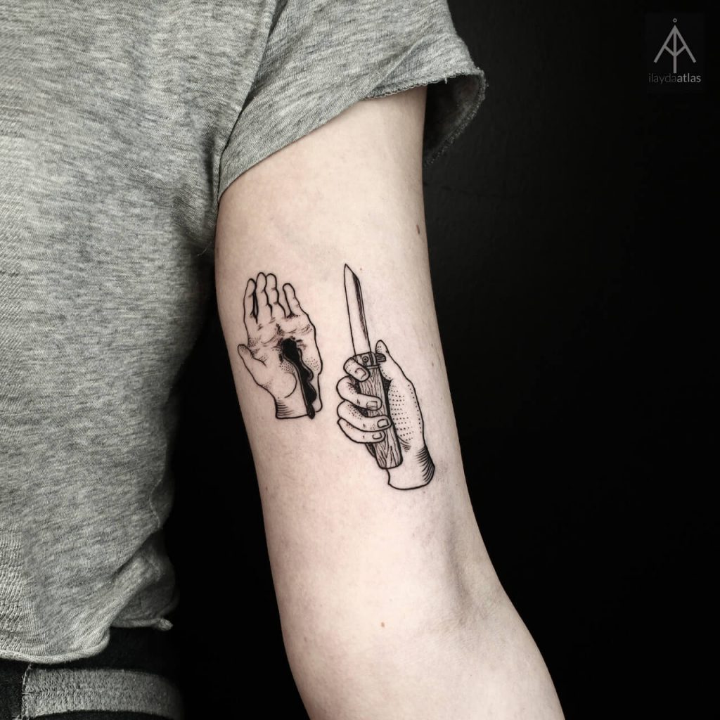 Hand and knife tattoo