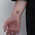 Hand-poked black and white Lotus tattoo