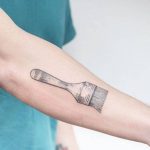 Hand-poked brush tattoo