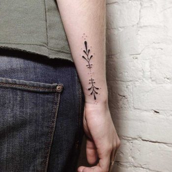 Hand-poked ornamental forearm tattoo