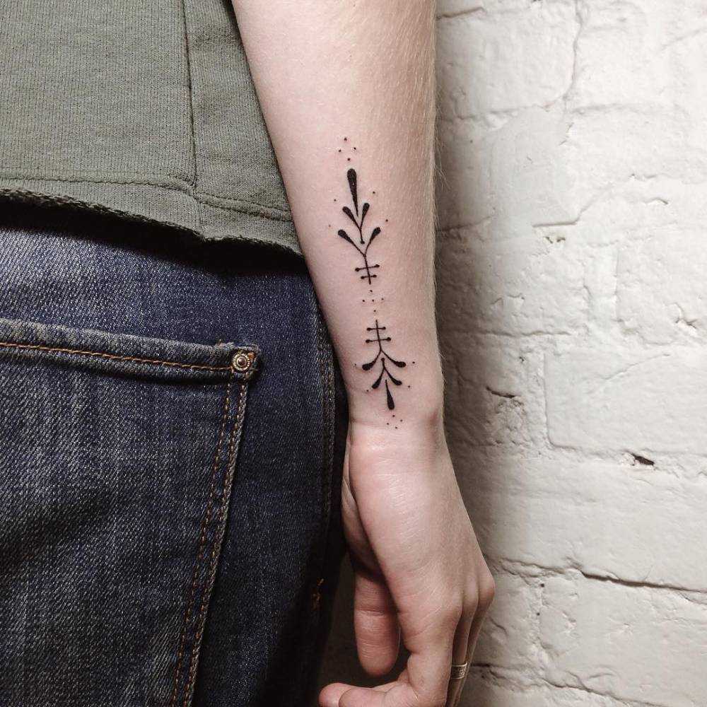 Hand-poked ornamental forearm tattoo