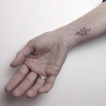 Hand-poked twig tattoo by Lara MJ
