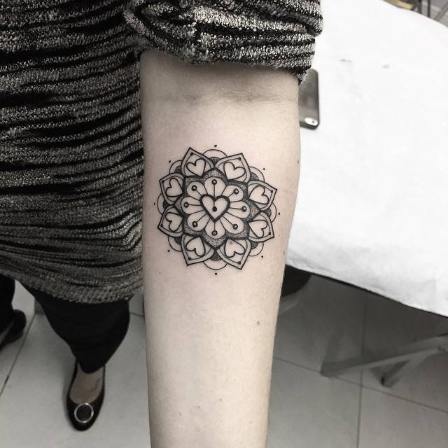 Heart mandala tattoo on the forearm