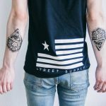 Matching forearm tattoos by Dogma Noir