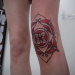 Red mandala tattoo on the knee