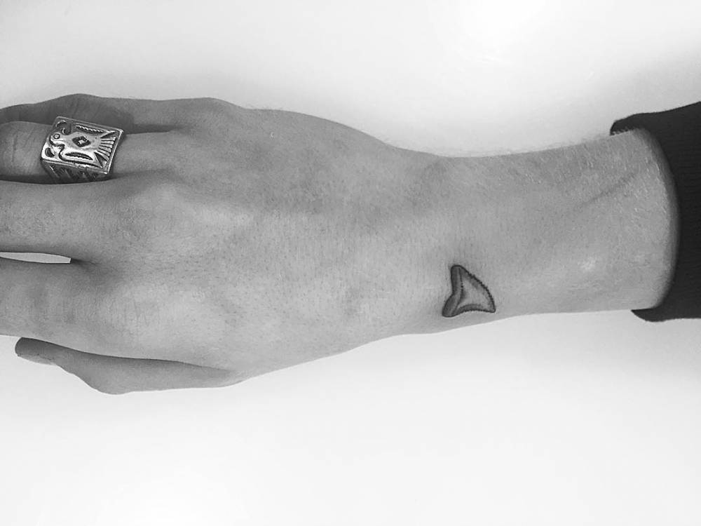 Shark fin tattoo by Cody Simpson