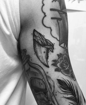 Shark tooth tattoo done at Primordial Pain Tattoo Studio