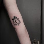 Small UFO tattoo on the arm