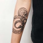 Snake tattoo on a forearm by Finley Jordan