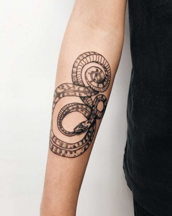 Snake tattoo on a forearm by Finley Jordan