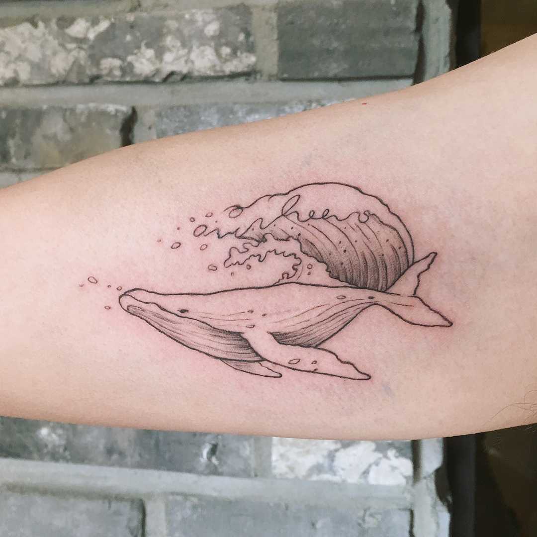 Surfing whale tattoo