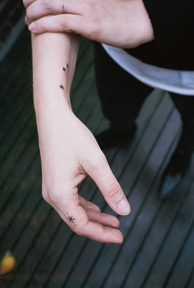 Tiny star tattoos on the arm