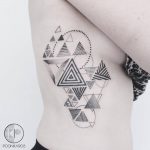 Triangular pattern tattoo on the rib cage