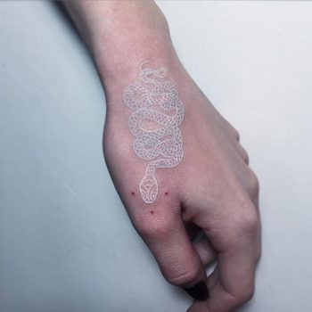 White snake tattoo on the left hand