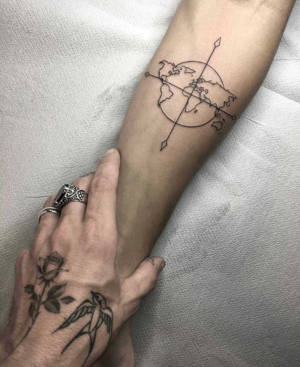 World map and compass tattoo