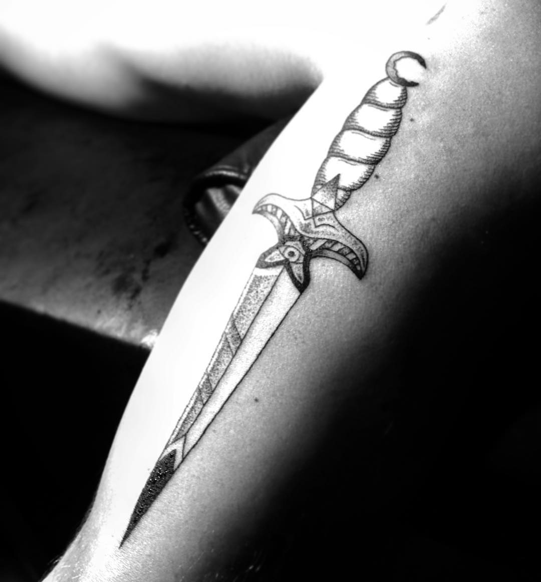 Black and grey dagger on the arm