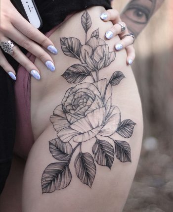 Black and grey rose tattoo on the hip