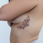 Black and grey rose underboob tattoo