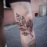 Black branch tattoo on the left leg