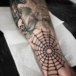 Black solid spider web tattoo