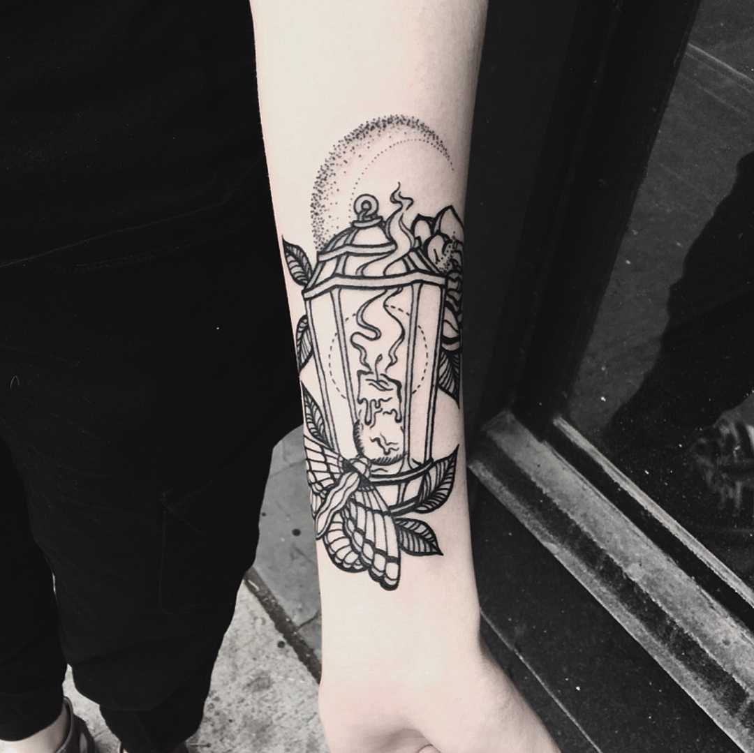 Blackwork lantern and moth tattoo