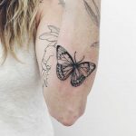 Butterfly tattoo on the left forearm
