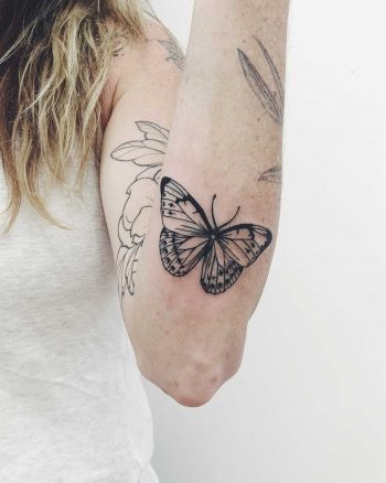 Butterfly tattoo on the left forearm