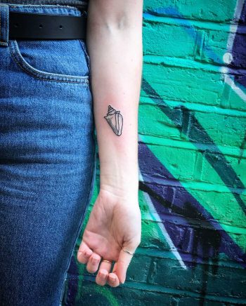 Conch shell tattoo by Kirk Budden