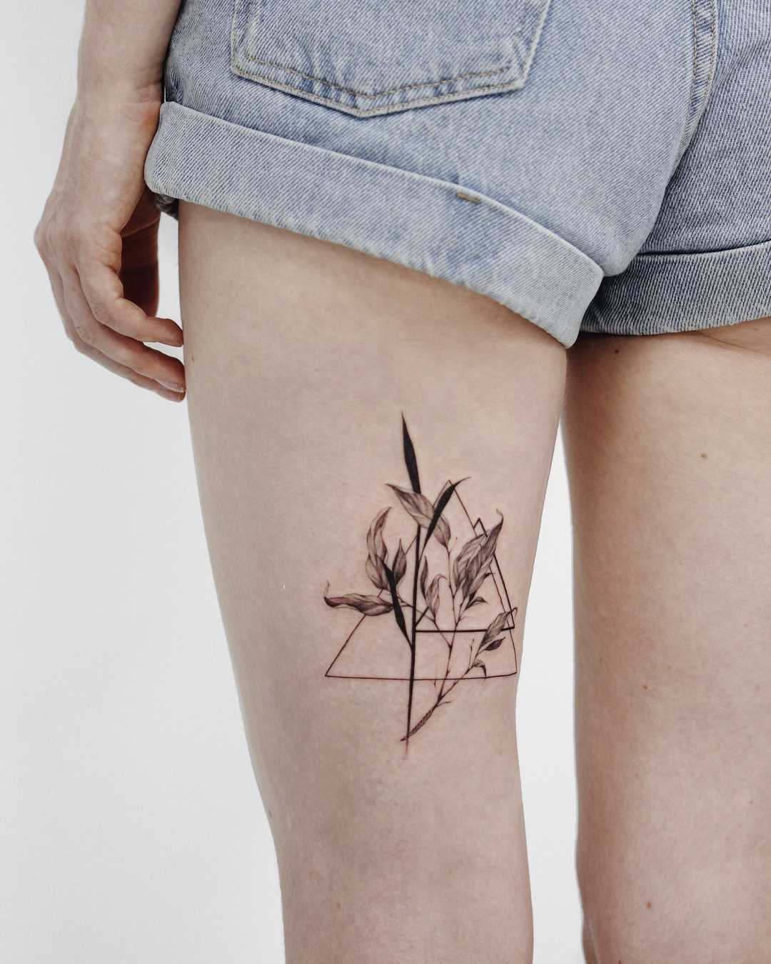 Delicate flowers and triangles tattoo