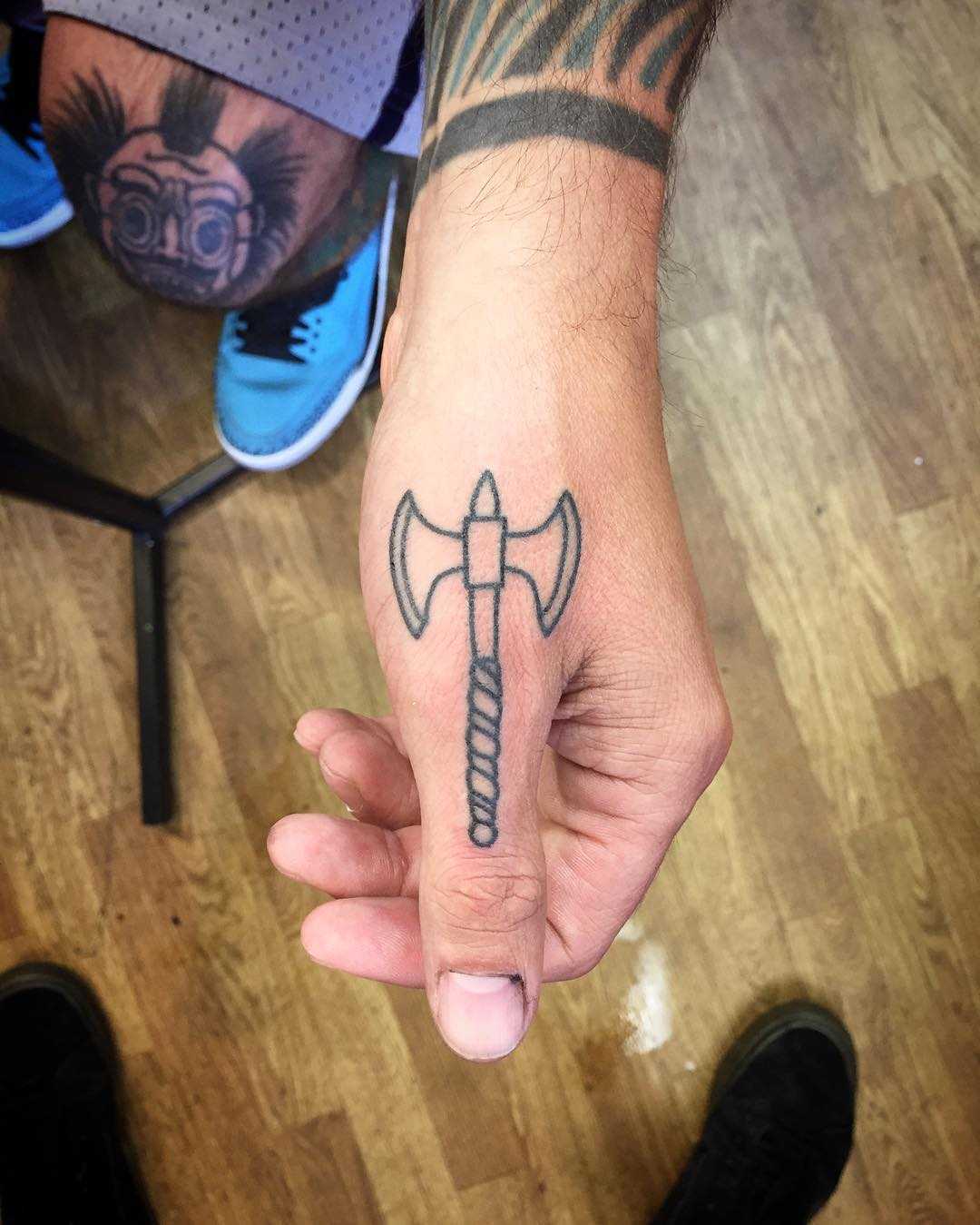 Double axe tattoo by Kirk Budden