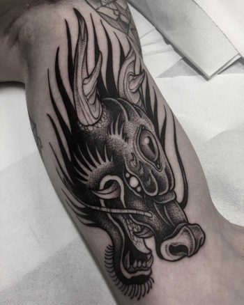 Dragon head tattoo done at Primordial Pain Tattoo Studio