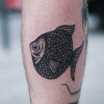 Flat fish tattoo on a calf