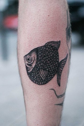 Flat fish tattoo on a calf