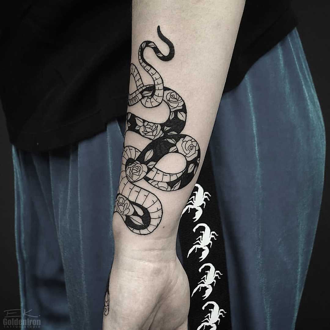 Floral black and white snake tattoo
