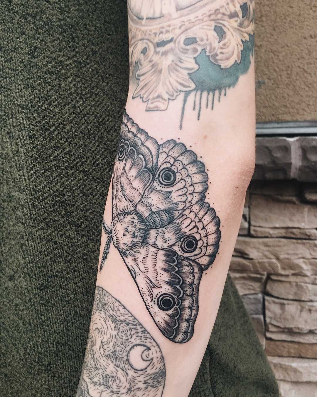 Furry moth tattoo by Finley Jordan