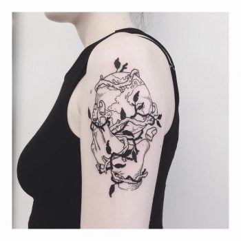 Hand holding Earth tattoo