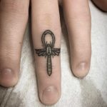 Hand-poked tiny ankh scarab beetle dragon by Kirk Budden