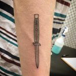 Handpoked knife tattoo by Kirk Budden