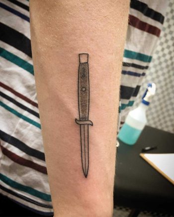 Handpoked knife tattoo by Kirk Budden