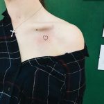 Little heart tattoo on the clavicle