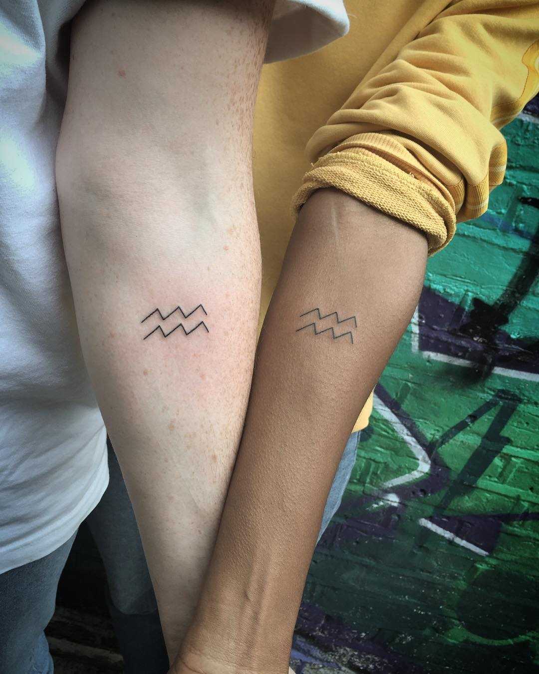 Matching Aquarius sign tattoos by Kirk Budden